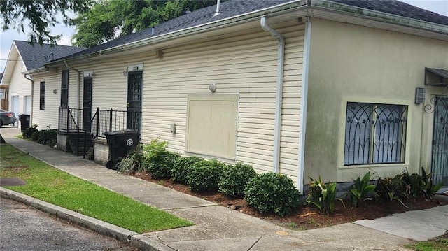 1740 Abundance St, New Orleans, LA 70119 - view of side of home with roof with shingles