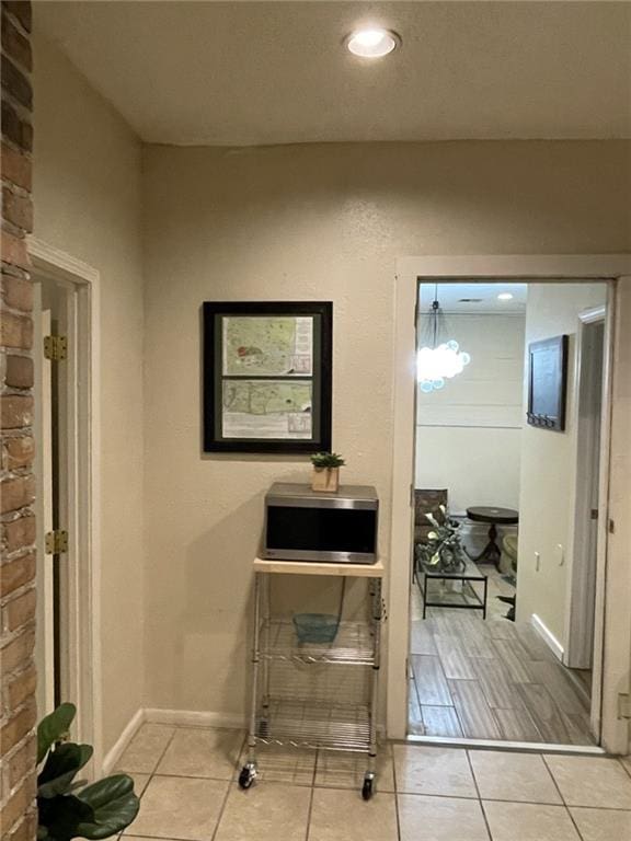 1740 Abundance St, New Orleans, LA 70119 - hallway with light tile patterned floors and baseboards