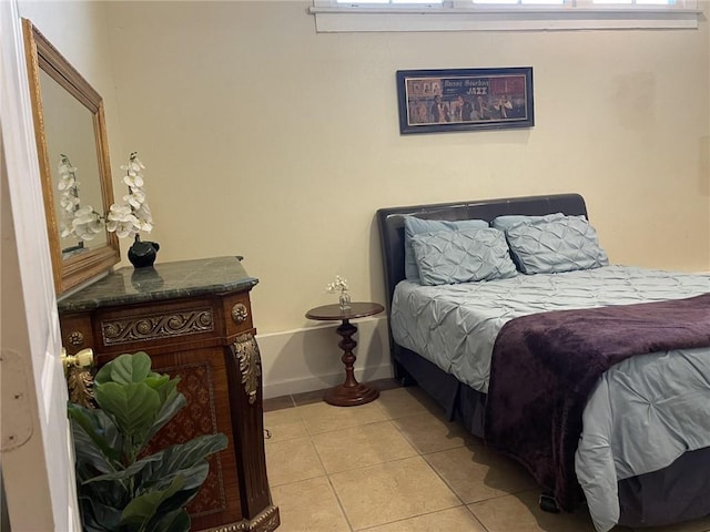 1740 Abundance St, New Orleans, LA 70119 - bedroom with multiple windows, light tile patterned flooring, and baseboards