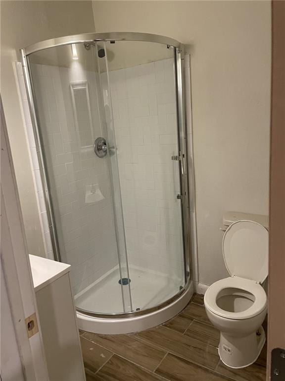 1740 Abundance St, New Orleans, LA 70119 - bathroom featuring a shower stall, toilet, wood tiled floors, and vanity
