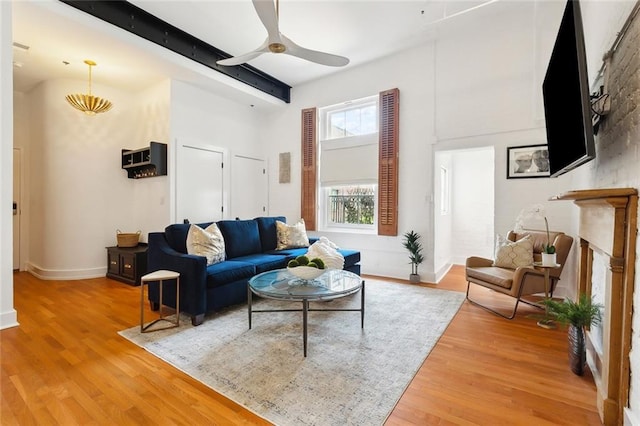 633 Tchoupitoulas St Unit 4, New Orleans, LA 70130 - living room featuring light wood-style flooring, ceiling fan, beam ceiling, baseboards, and a towering ceiling