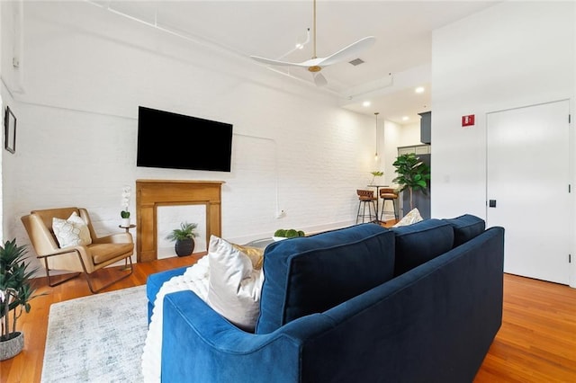 633 Tchoupitoulas St Unit 4, New Orleans, LA 70130 - living room featuring a ceiling fan, wood finished floors, recessed lighting, and a fireplace