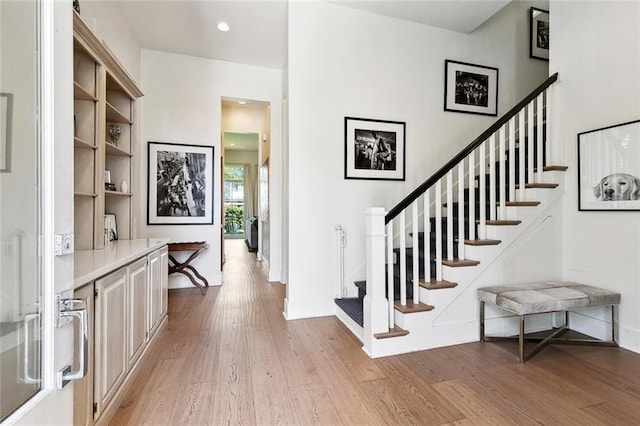 1113 9th St, New Orleans, LA 70115 - entrance foyer featuring light wood-style flooring, stairway, baseboards, and recessed lighting