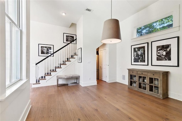 1113 9th St, New Orleans, LA 70115 - foyer featuring a towering ceiling, stairway, hardwood / wood-style flooring, and baseboards