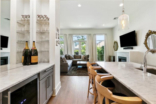 1113 9th St, New Orleans, LA 70115 - kitchen featuring a fireplace, open floor plan, wine cooler, a sink, and recessed lighting
