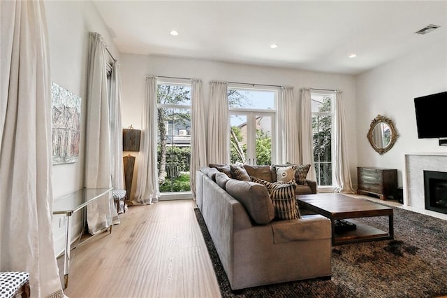 1113 9th St, New Orleans, LA 70115 - living room featuring wood finished floors, a high end fireplace, and recessed lighting