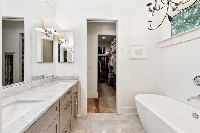 1113 9th St, New Orleans, LA 70115 - full bathroom with a soaking tub, double vanity, a spacious closet, and baseboards