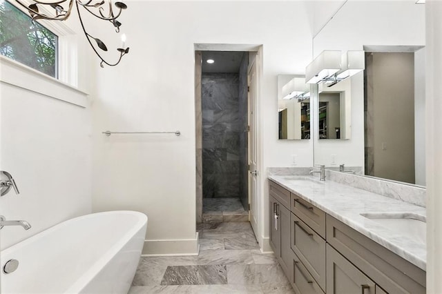 1113 9th St, New Orleans, LA 70115 - full bath with marble finish flooring, a freestanding bath, double vanity, baseboards, and a tile shower