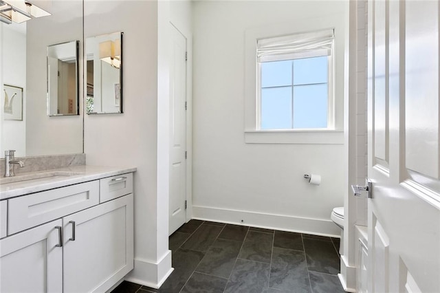 1113 9th St, New Orleans, LA 70115 - bathroom featuring vanity, toilet, and baseboards