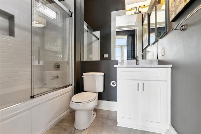 1113 9th St, New Orleans, LA 70115 - full bathroom with toilet, bath / shower combo with glass door, vanity, and baseboards
