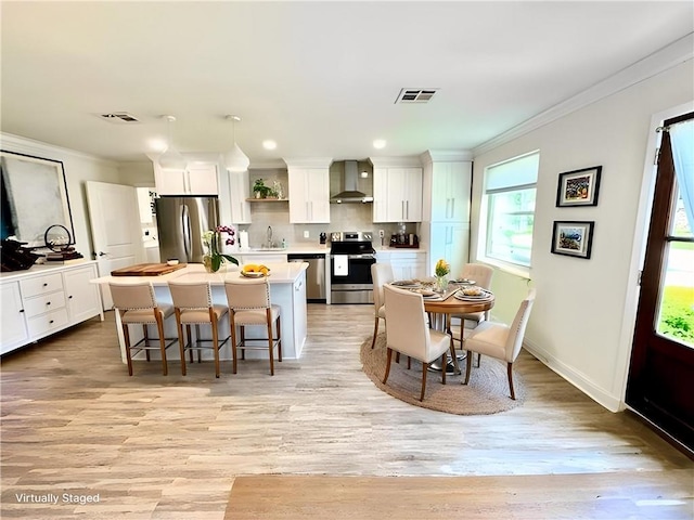 917 Belmont Pl, Metairie, LA 70001 - dining area with ornamental molding, light wood finished floors, and recessed lighting