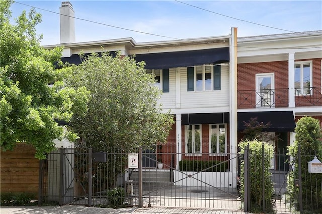 1427 Leontine St New O, Unit New O, New Orleans, LA 70115 - view of front facade with brick siding, a gate, and a fenced front yard