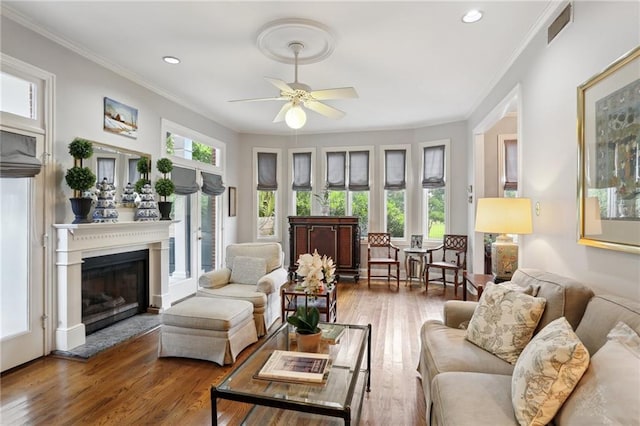 1427 Leontine St New O, Unit New O, New Orleans, LA 70115 - living room with a glass covered fireplace, a ceiling fan, ornamental molding, wood finished floors, and recessed lighting