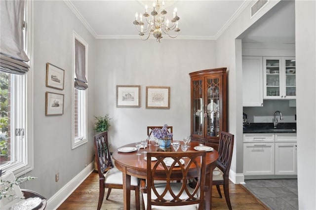 1427 Leontine St New O, Unit New O, New Orleans, LA 70115 - dining room with dark wood-style floors, a chandelier, crown molding, and baseboards