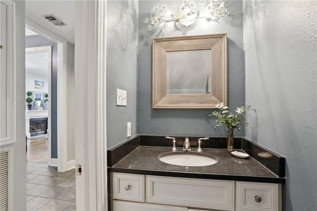 1427 Leontine St New O, Unit New O, New Orleans, LA 70115 - bathroom with tile patterned floors, vanity, a textured wall, and a fireplace