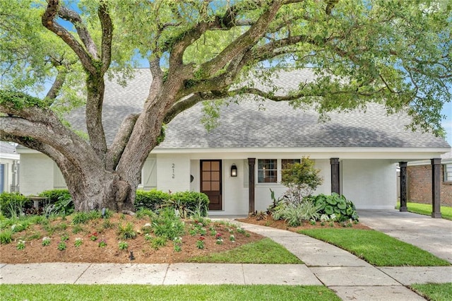 212 Nelson Dr, River Ridge, LA 70123 - view of front of house with roof with shingles, concrete driveway, and a carport