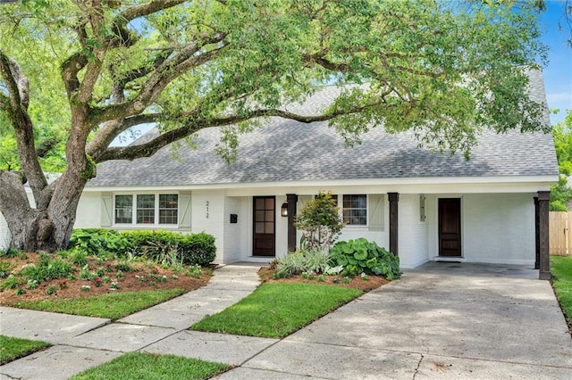 212 Nelson Dr, River Ridge, LA 70123 - view of front of property with a shingled roof, brick siding, and concrete driveway