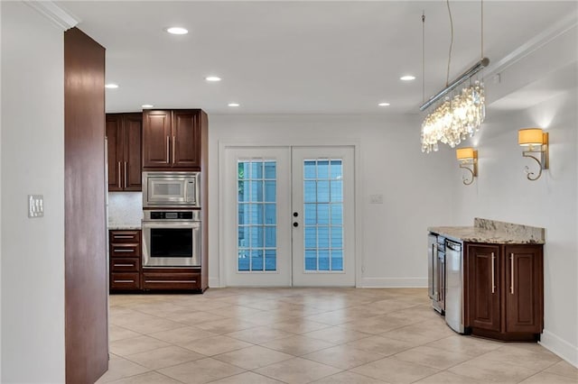 212 Nelson Dr, River Ridge, LA 70123 - kitchen with appliances with stainless steel finishes, french doors, baseboards, light stone countertops, and recessed lighting
