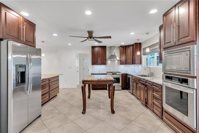212 Nelson Dr, River Ridge, LA 70123 - kitchen featuring stainless steel appliances, wall chimney range hood, a sink, a ceiling fan, and light stone countertops