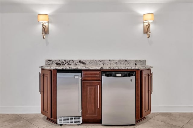 212 Nelson Dr, River Ridge, LA 70123 - bar featuring light tile patterned floors, baseboards, and refrigerator