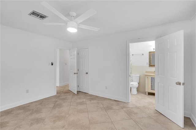 212 Nelson Dr, River Ridge, LA 70123 - unfurnished bedroom featuring crown molding, ensuite bathroom, light tile patterned floors, baseboards, and a ceiling fan