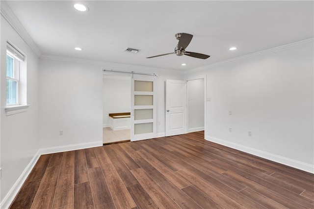 212 Nelson Dr, River Ridge, LA 70123 - unfurnished bedroom featuring wood finished floors, recessed lighting, baseboards, crown molding, and a barn door