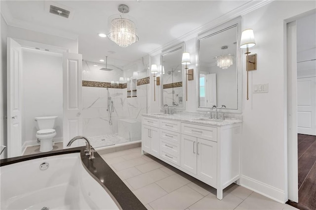 212 Nelson Dr, River Ridge, LA 70123 - bathroom featuring a marble finish shower, a chandelier, double vanity, toilet, and a garden tub