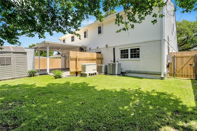 212 Nelson Dr, River Ridge, LA 70123 - rear view of property with a gate, central AC unit, and brick siding