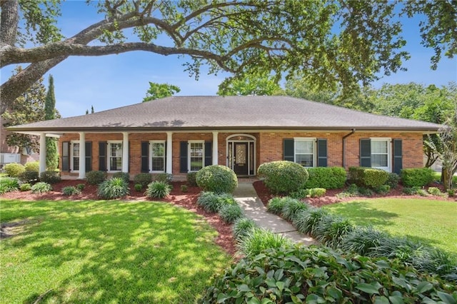 653 Fairfield Ave, Gretna, LA 70056 - ranch-style house featuring a front lawn, brick siding, and a porch