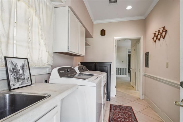 653 Fairfield Ave, Gretna, LA 70056 - laundry area featuring separate washer and dryer, cabinet space, crown molding, light tile patterned floors, and baseboards