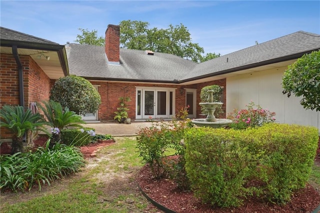 653 Fairfield Ave, Gretna, LA 70056 - back of house with brick siding, a chimney, roof with shingles, and french doors