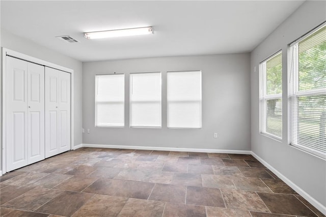 150 Manor Dr, Ponchatoula, LA 70454 - unfurnished bedroom featuring baseboards, stone finish flooring, and a closet