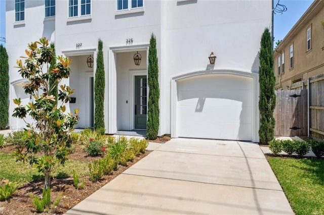 325 Focis St, Metairie, LA 70005 - view of front facade featuring an attached garage, driveway, and stucco siding