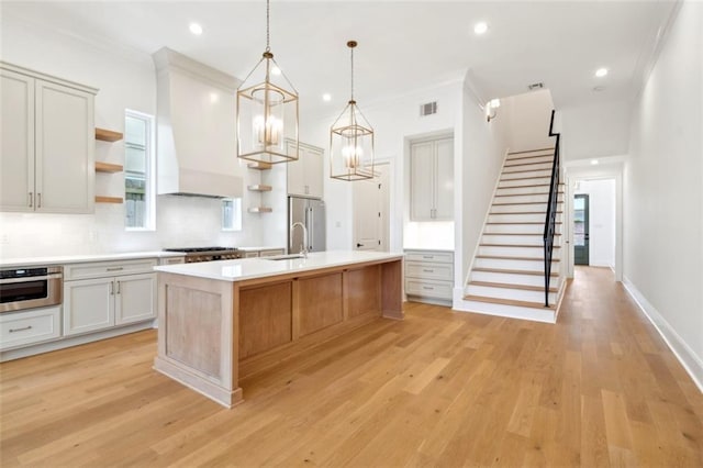 325 Focis St, Metairie, LA 70005 - kitchen with open shelves, a sink, appliances with stainless steel finishes, backsplash, and light wood-type flooring