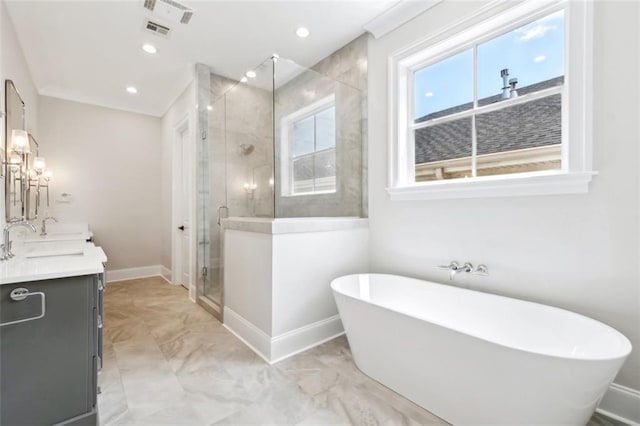 325 Focis St, Metairie, LA 70005 - bathroom featuring double vanity, a shower stall, a soaking tub, baseboards, and marble look tiles