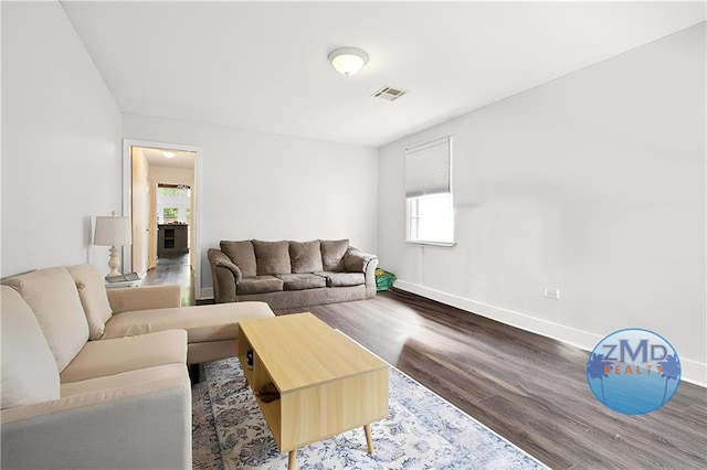 4819 Touro St, New Orleans, LA 70122 - living area with wood finished floors, plenty of natural light, and baseboards