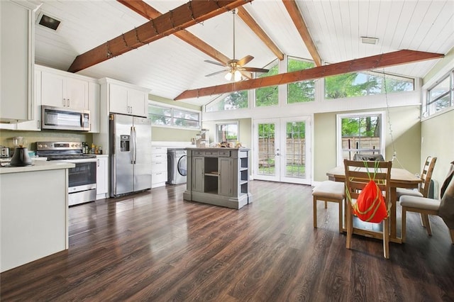 4819 Touro St, New Orleans, LA 70122 - kitchen with stainless steel appliances, beamed ceiling, light countertops, dark wood-type flooring, and washer / dryer