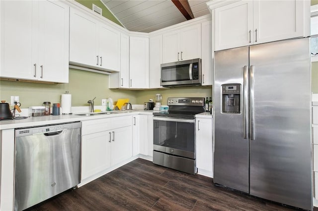 4819 Touro St, New Orleans, LA 70122 - kitchen featuring stainless steel appliances, a sink, dark wood-style floors, light countertops, and white cabinetry
