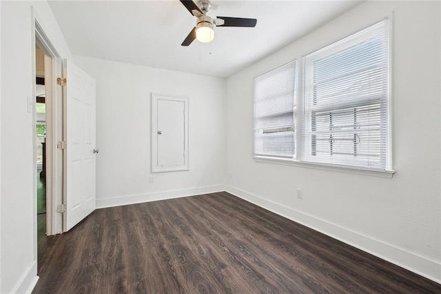 4819 Touro St, New Orleans, LA 70122 - unfurnished room with healthy amount of natural light, baseboards, dark wood finished floors, and a ceiling fan