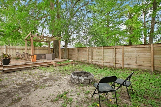 4819 Touro St, New Orleans, LA 70122 - fenced backyard featuring an outdoor fire pit, a deck, and a pergola