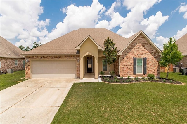 422 Scotch Pine Dr, Ponchatoula, LA 70454 - view of front facade featuring an attached garage, concrete driveway, brick siding, a front lawn, and roof with shingles