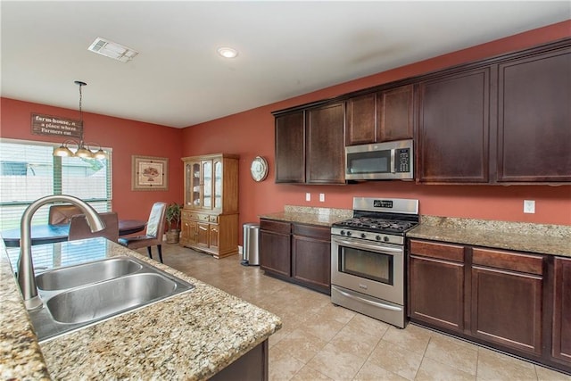 422 Scotch Pine Dr, Ponchatoula, LA 70454 - kitchen with stainless steel appliances, a sink, decorative light fixtures, dark brown cabinetry, and recessed lighting