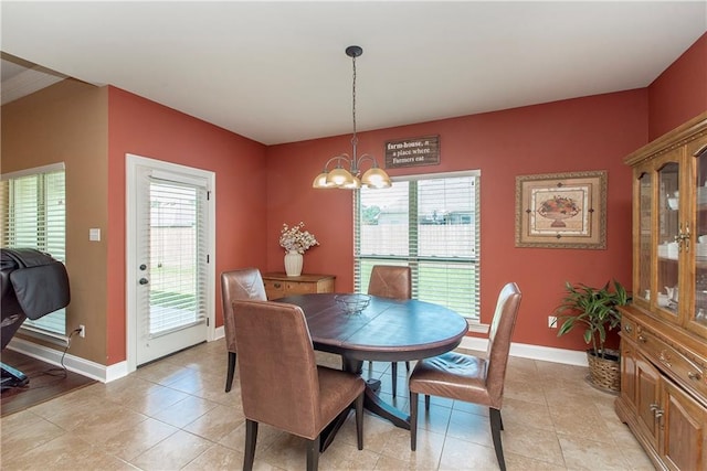 422 Scotch Pine Dr, Ponchatoula, LA 70454 - dining room with a chandelier, baseboards, and light tile patterned floors