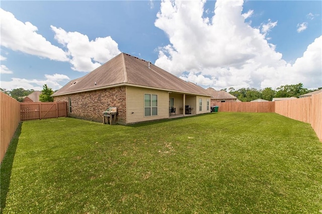 422 Scotch Pine Dr, Ponchatoula, LA 70454 - rear view of house with brick siding and a patio area