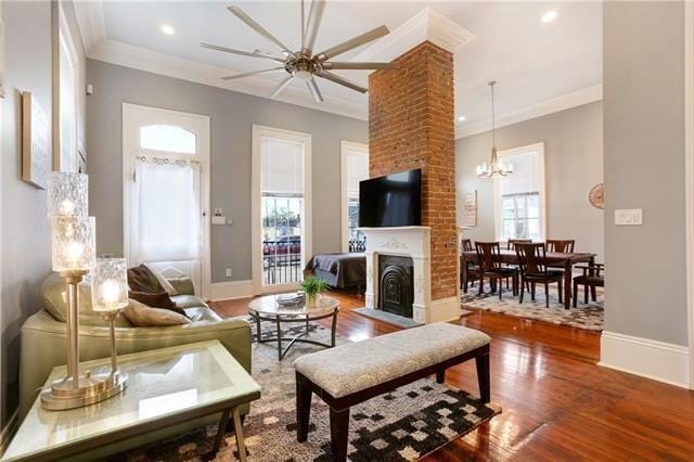 1355 Columbus St, New Orleans, LA 70116 - living room featuring plenty of natural light, crown molding, a fireplace with flush hearth, wood finished floors, and a ceiling fan