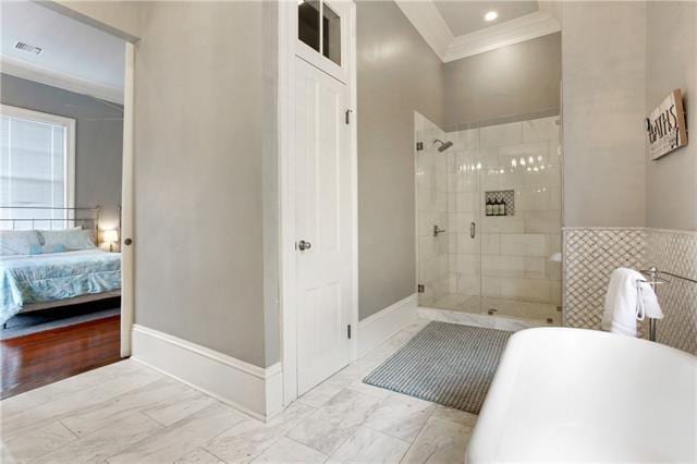 1355 Columbus St, New Orleans, LA 70116 - full bath featuring marble look tiles, a soaking tub, ornamental molding, a shower stall, and ensuite bath