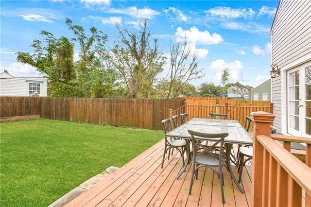 1355 Columbus St, New Orleans, LA 70116 - deck with a fenced backyard, outdoor dining area, and french doors