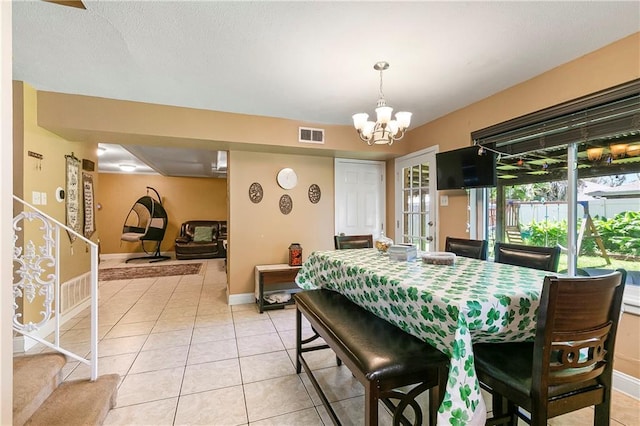 65 Monterrey Dr, Kenner, LA 70065 - dining area with stairs, light tile patterned floors, a chandelier, and baseboards