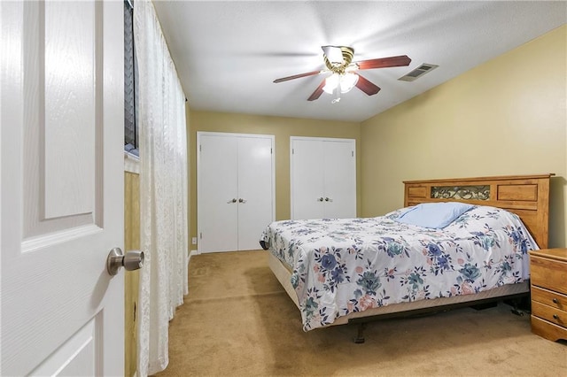65 Monterrey Dr, Kenner, LA 70065 - bedroom with light carpet, a ceiling fan, and multiple closets