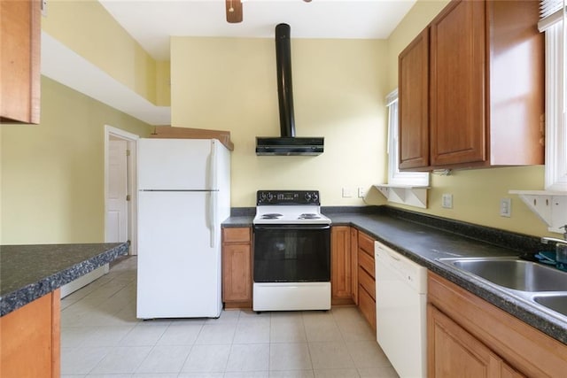 5655 Hawthorne Pl, New Orleans, LA 70124 - kitchen featuring white appliances, under cabinet range hood, dark countertops, light tile patterned floors, and brown cabinets